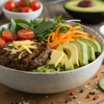 Close-up of a vibrant and nutritious burger bowl with grilled beef patty, fresh vegetables, avocado, and cheese, perfect for a healthy, customizable meal.