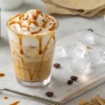 A refreshing and creamy whipped maple iced coffee with a frothy topping and maple syrup drizzle, perfect for a sweet, cold beverage treat.