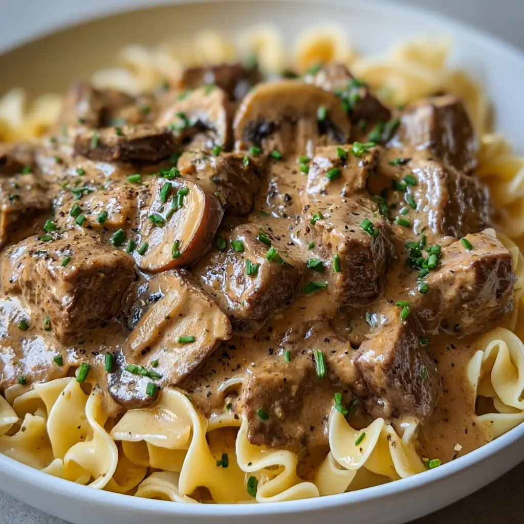 final creamy beef stroganoff slow cooker served over noodles